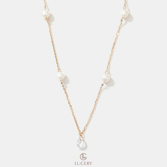 Suspended on a delicate 18K champagne gold-plated S925 silver chain, lustrous freshwater pearls interplay with sparkling zirconia, creating a vision of morning elegance. This necklace drapes the neckline with a serene and romantic allure.