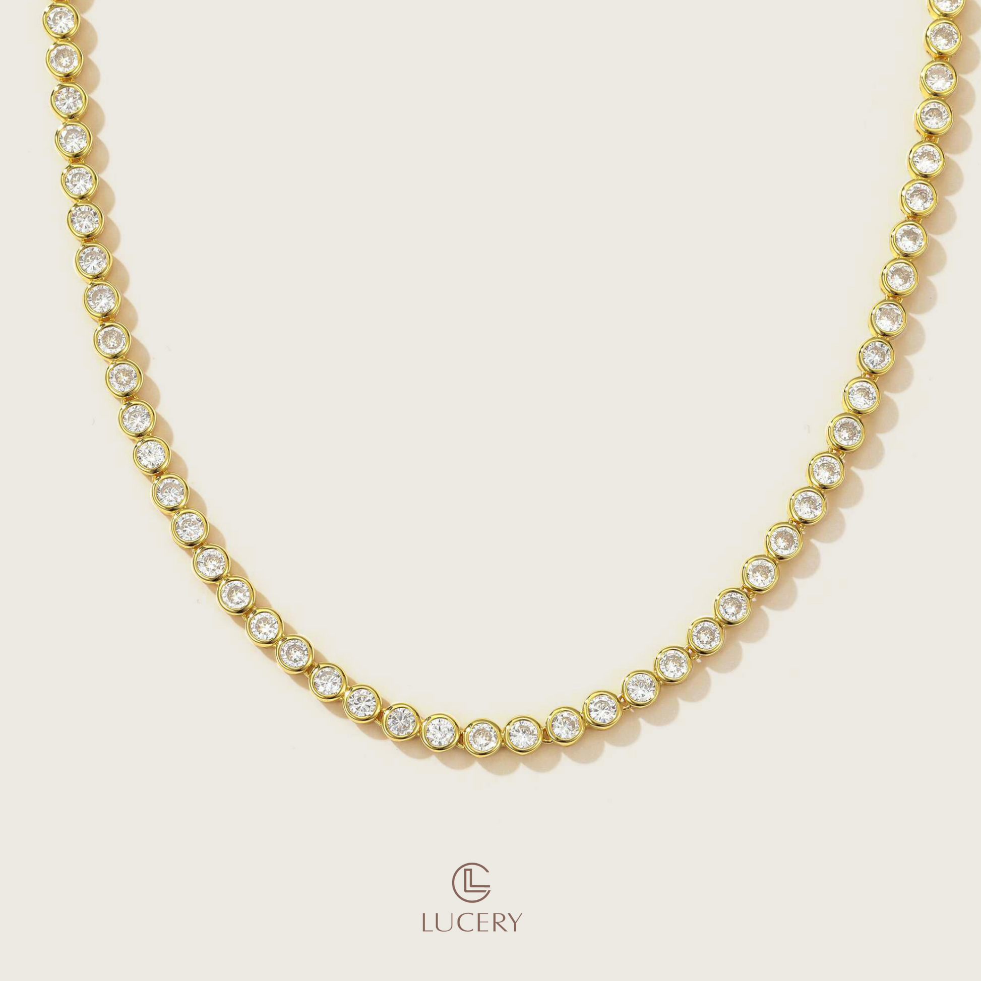 The Golden Glow Zirconia Necklace encircles your neck with a radiant band of zirconia, each stone set in a golden frame to catch and reflect light with every movement.