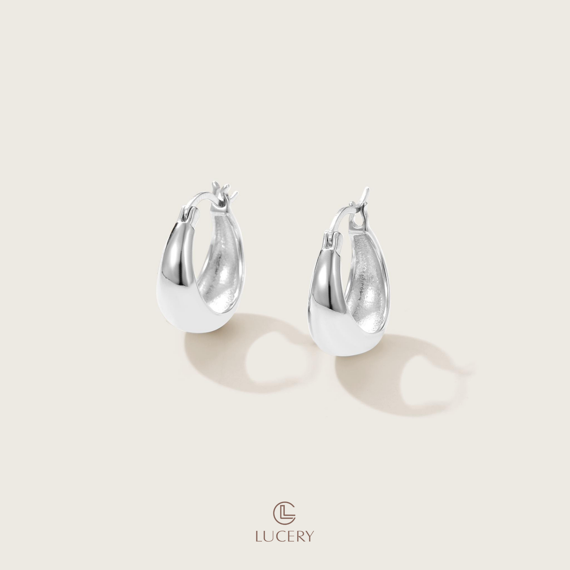 The Sleek Crescent Hoop Earrings offer a modern silhouette with a polished finish, ideal for a refined touch to any ensemble. Their elegant curve makes a subtle yet impactful style statement.