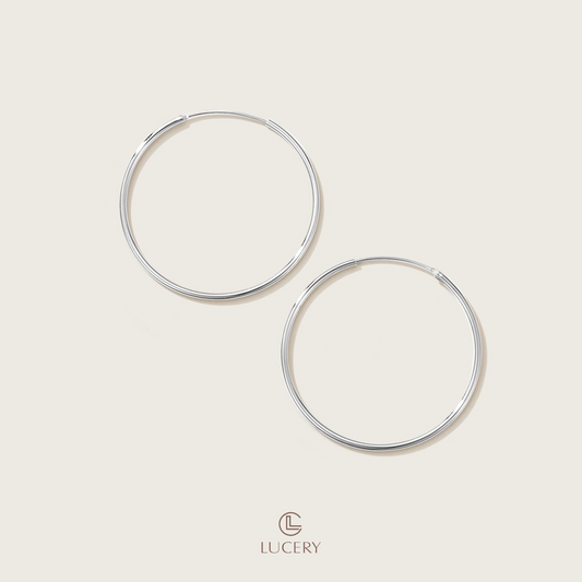 Experience understated elegance with our Essential Thin Hoop Earrings, featuring a slender and sleek design. These hoops offer a versatile style that complements any outfit, embodying simplicity and sophistication.