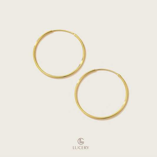 Experience understated elegance with our Essential Thin Hoop Earrings, featuring a slender and sleek design. These hoops offer a versatile style that complements any outfit, embodying simplicity and sophistication.