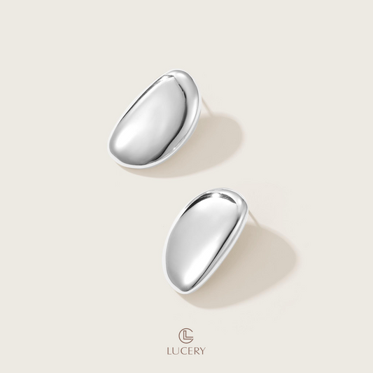 Step into a world of subtle grace with our Lustrous Teardrop Hoops, a perfect harmony of elegance and simplicity. Their smooth, droplet silhouette offers a versatile charm, elevating any ensemble effortlessly.