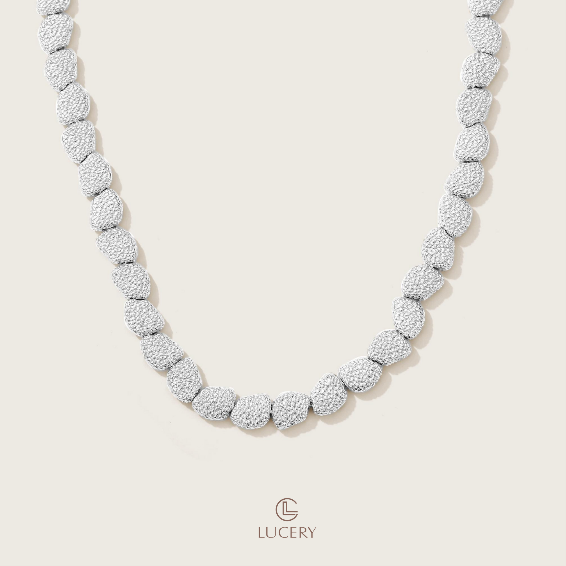 This necklace is a masterpiece of texture, with each gold element crafted to create a rich tapestry of light and shadow, wrapping the neck in a display of classical luxury.