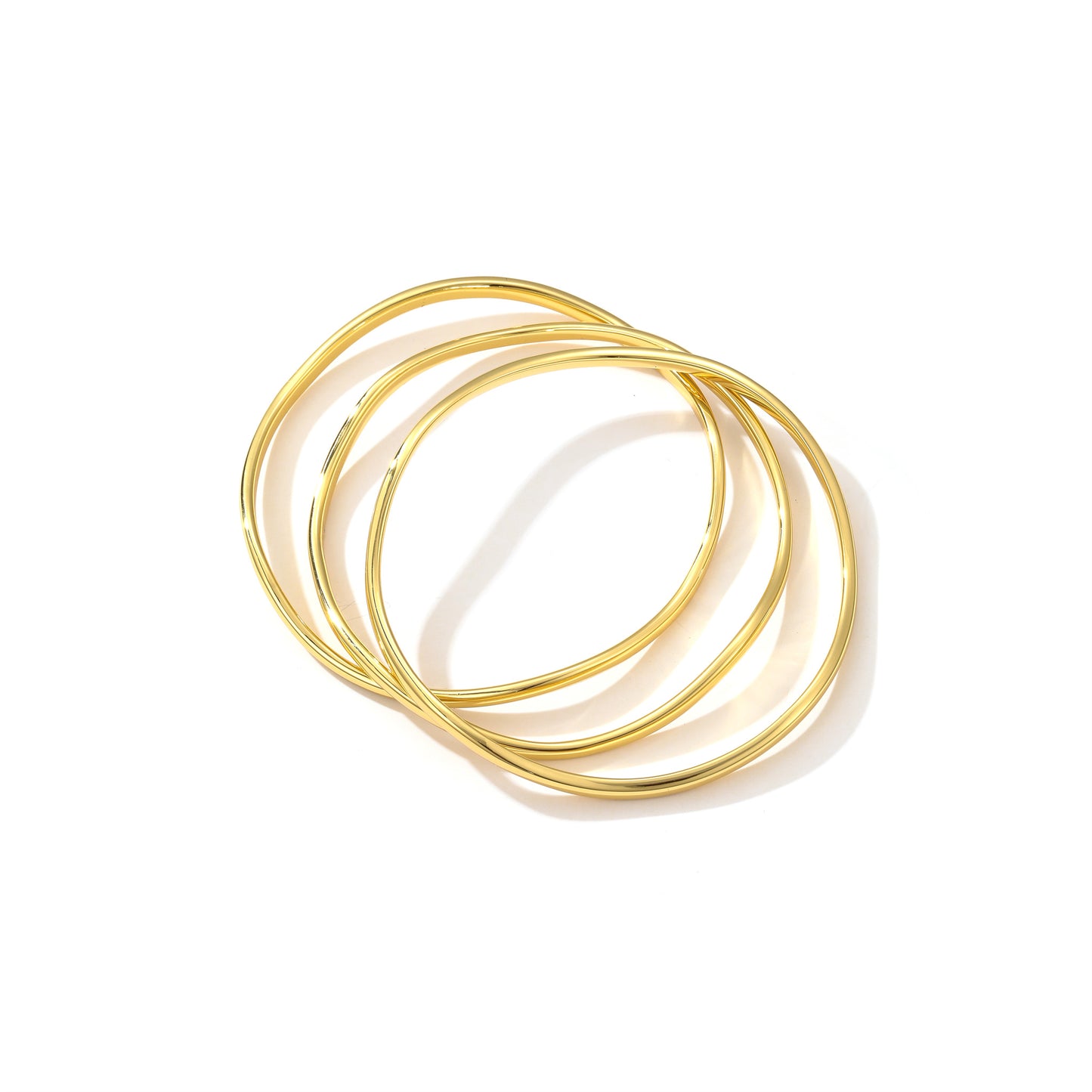 Elevate your wristwear with this trio of 18K gold-plated S925 silver bangles. Their intertwined design creates a dance of light and shadow, perfect for a touch of everyday elegance. Slim yet striking, they're an effortless statement piece.