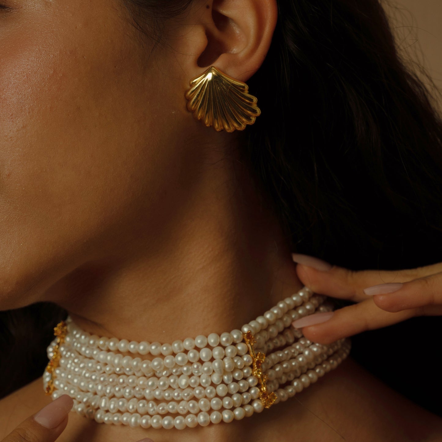 Behold the crown jewel of our collection: eight strands of lustrous, near-round freshwater pearls, each strand woven with delicate gold-plated petals and sparkling zirconia. This statement piece exudes opulence, perfect for gala events where its allure can shine.