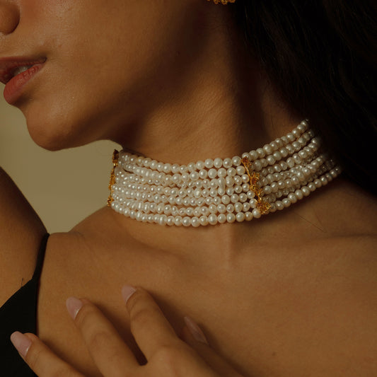 Behold the crown jewel of our collection: eight strands of lustrous, near-round freshwater pearls, each strand woven with delicate gold-plated petals and sparkling zirconia. This statement piece exudes opulence, perfect for gala events where its allure can shine.