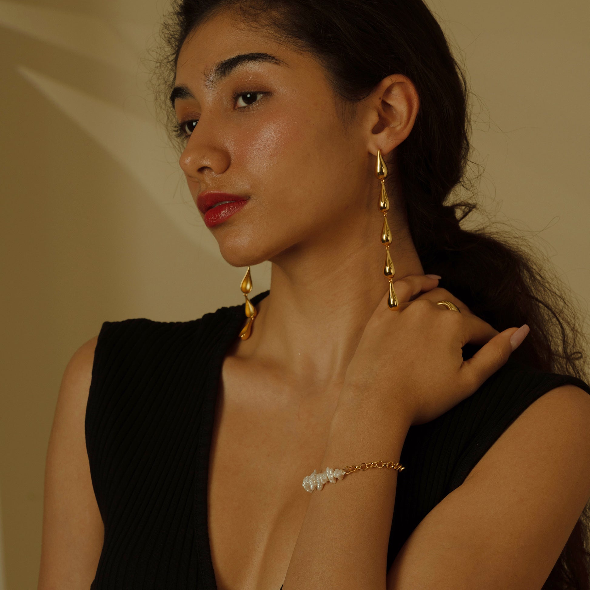 Embrace the fluidity of grace with these Cascading Elegance Earrings, featuring a harmonious series of teardrop shapes that descend with sophistication. Available in classic gold and sleek silver tones, they are perfect for versatile styling and timeless allure.