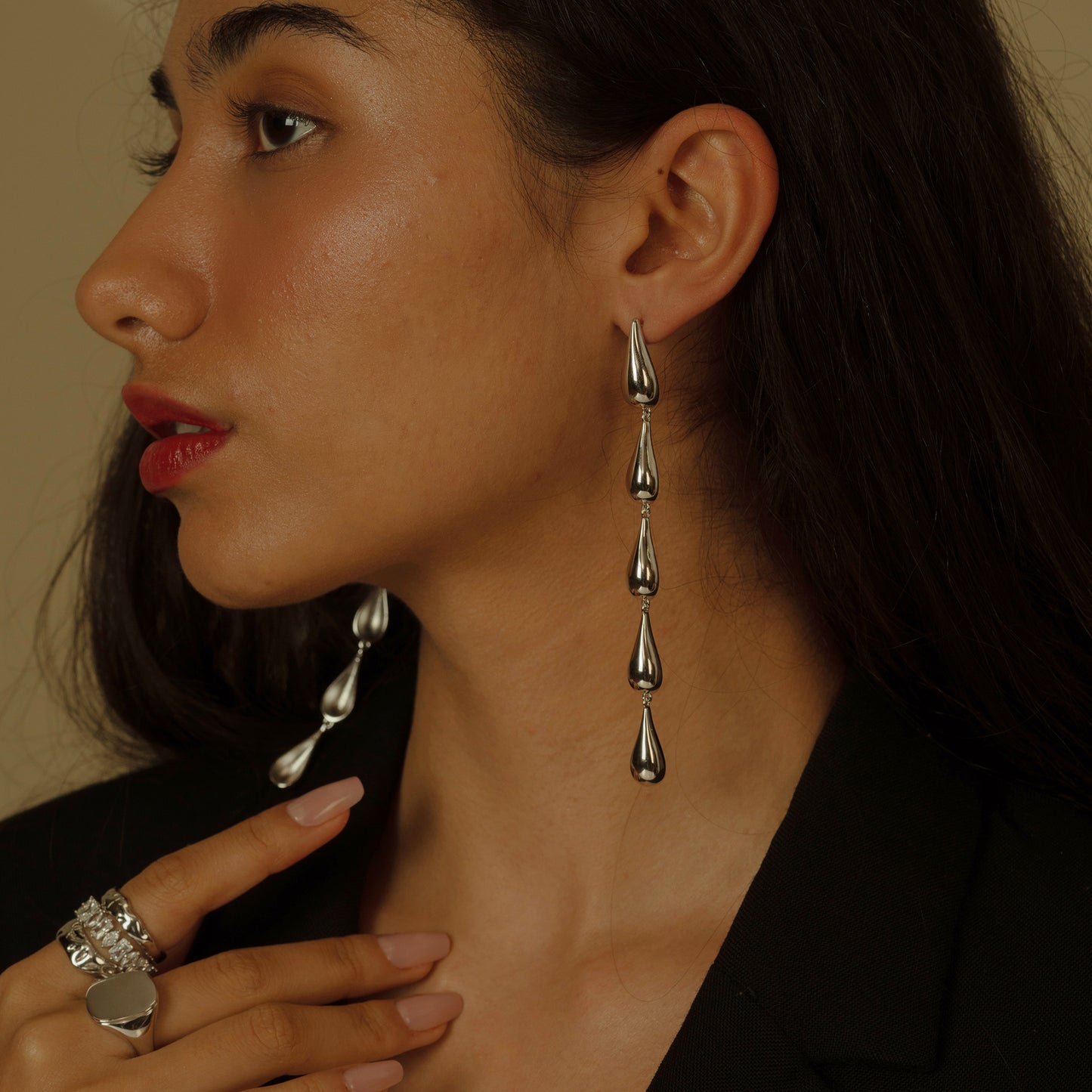 Embrace the fluidity of grace with these Cascading Elegance Earrings, featuring a harmonious series of teardrop shapes that descend with sophistication. Available in classic gold and sleek silver tones, they are perfect for versatile styling and timeless allure.